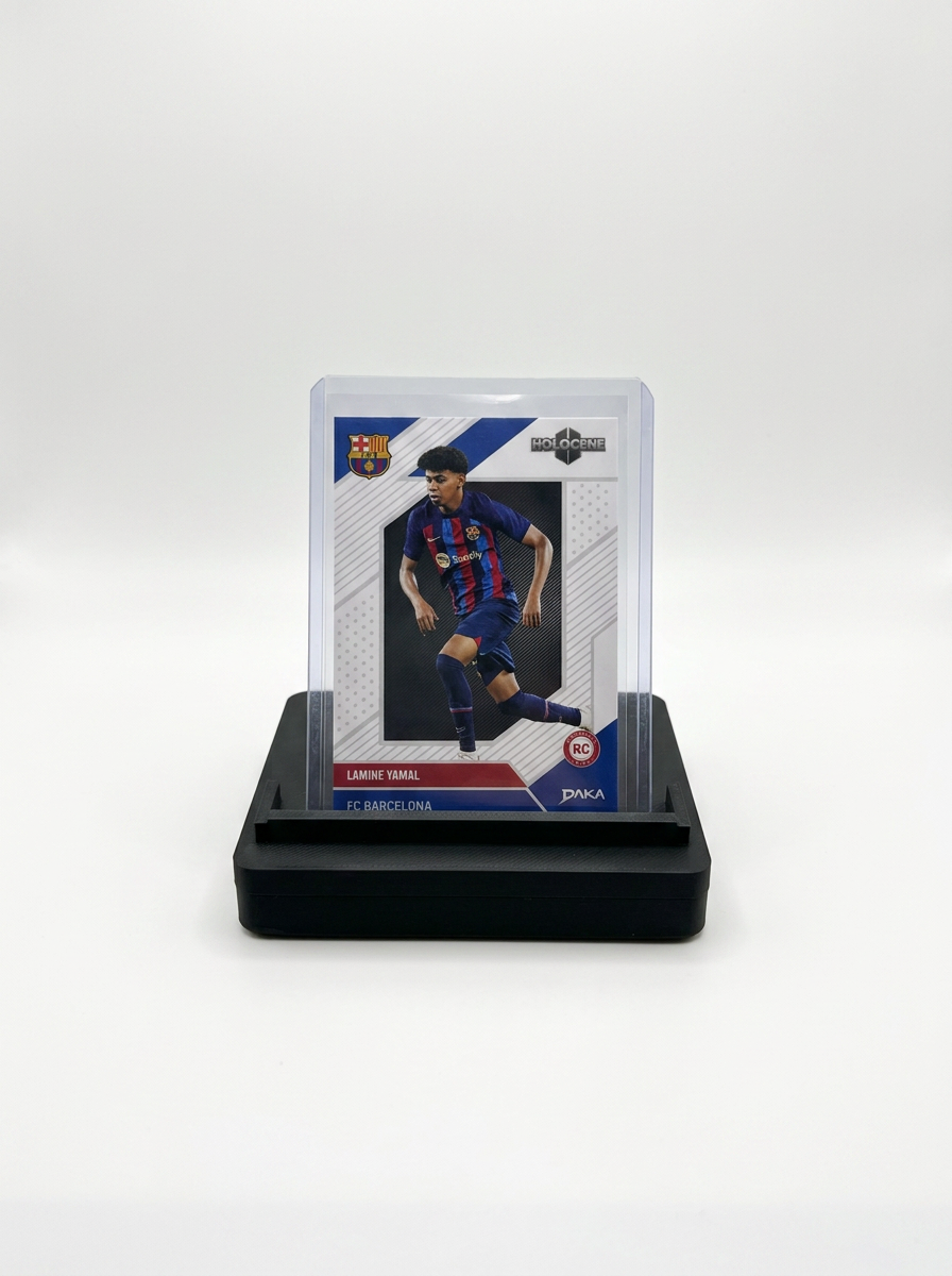 GO-001 holding a Lamine Yamal card in a top loader